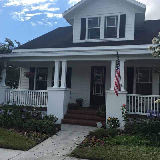 exterior of white home with large front porch