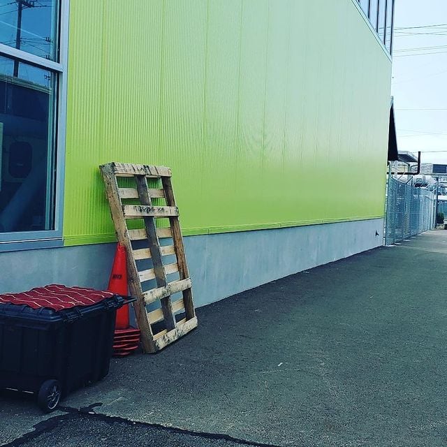 freshly painted green side of commercial building