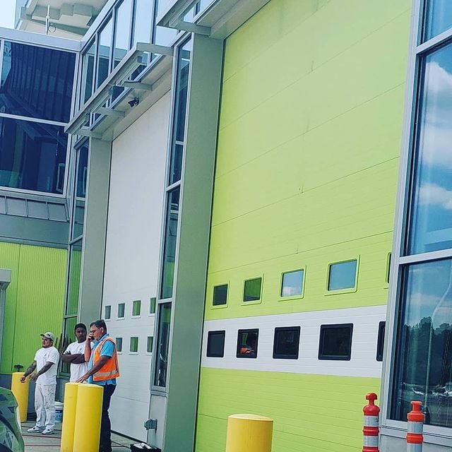 freshly painted green side of commercial building