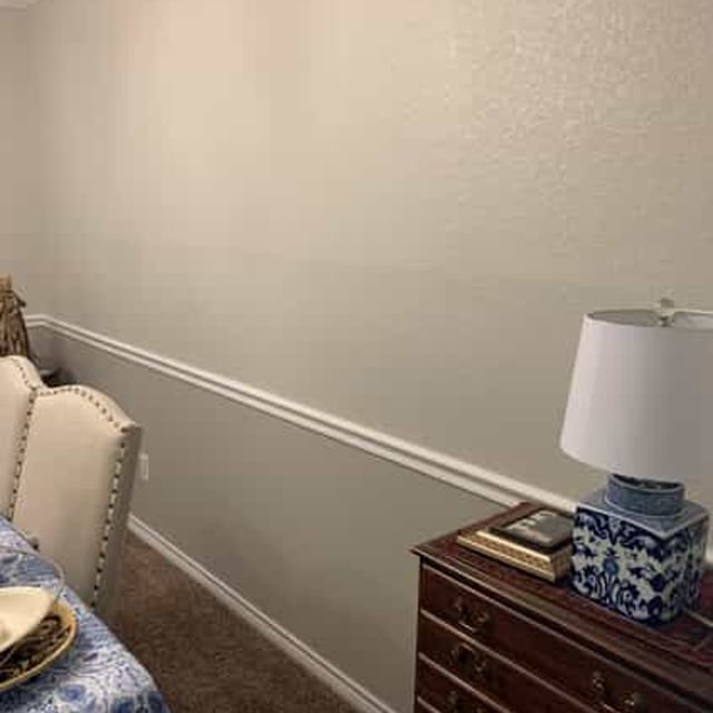 gray dining room wall and wood cabinet