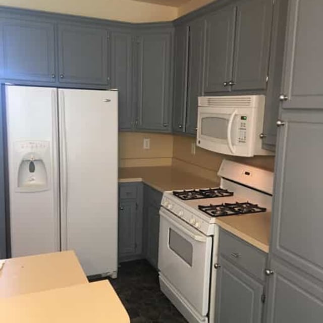 gray kitchen with white appliances 