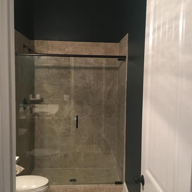 green bathroom with tile shower 