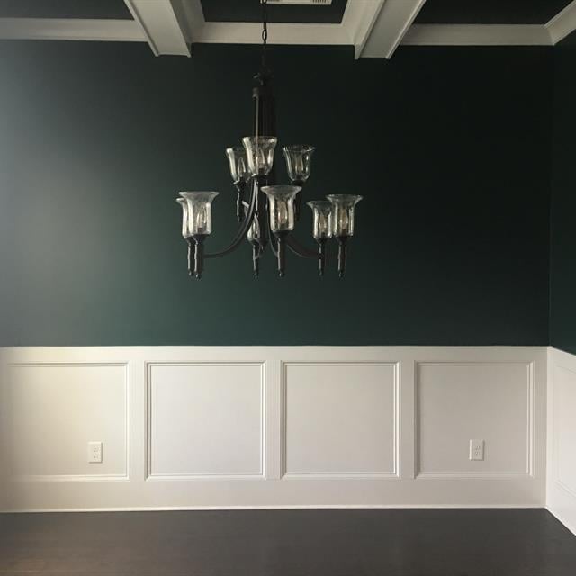 green dining room with hanging light fixture