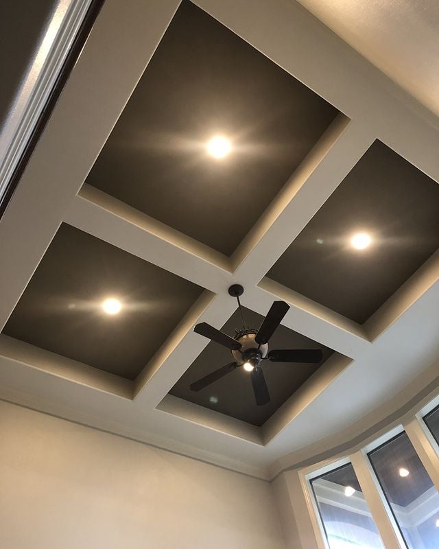 grey ceiling with black ceiling fan