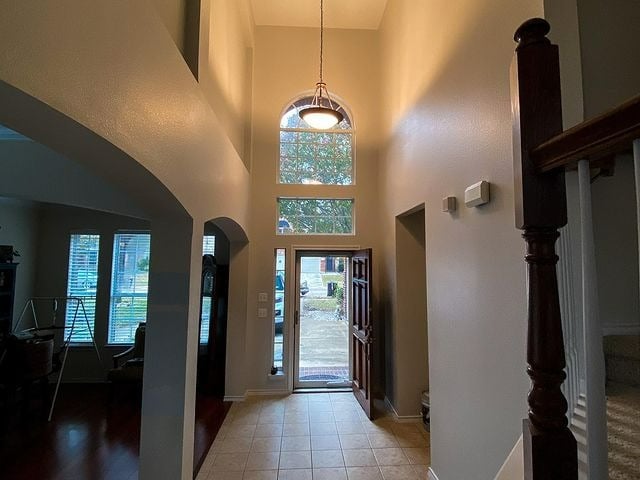 grey front entrance room with tile flooring