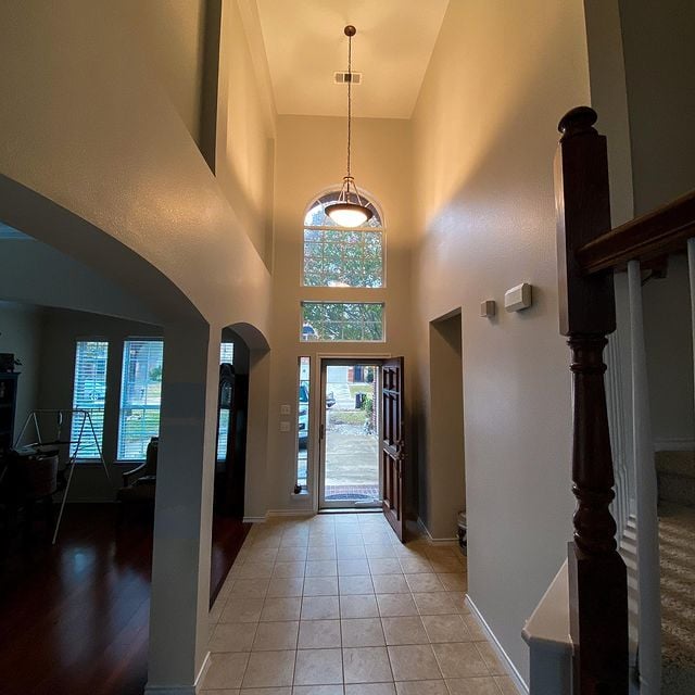 grey front entrance room with tile flooring