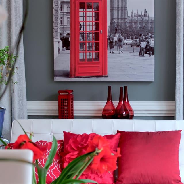 grey living room with white trim and red accents