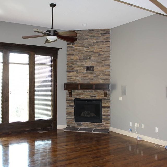 grey room with a stone fireplace