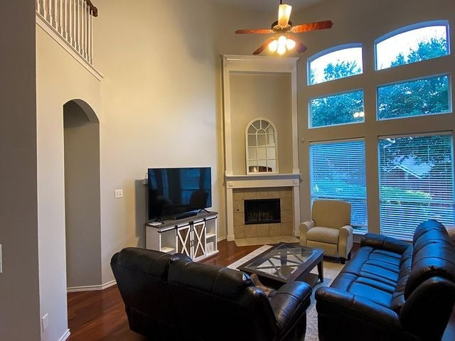 Grey room with brown leather couches and fireplace