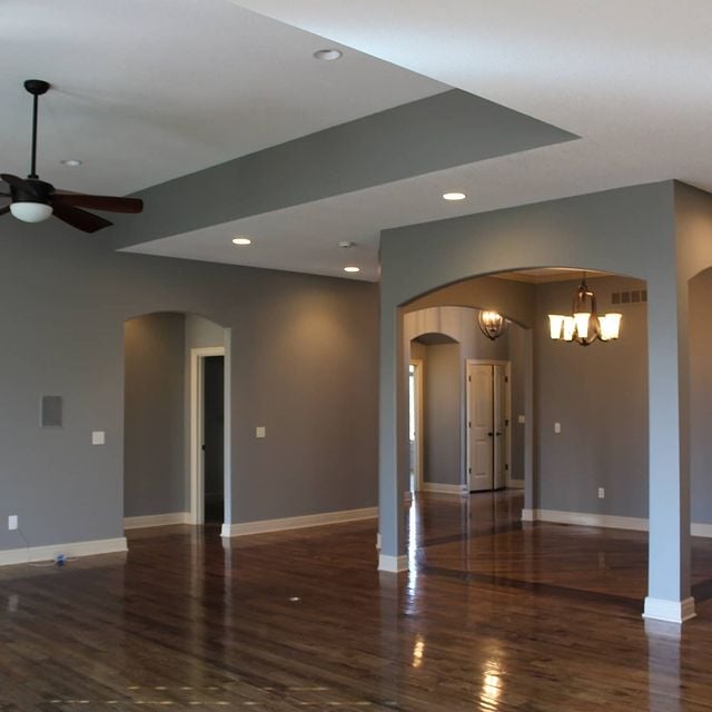 grey room with hardwood flooring