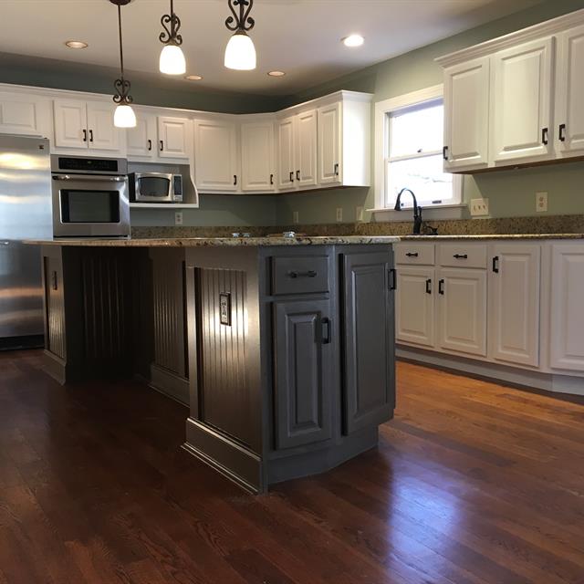 interior kitchen cabinets, flooring, and counter