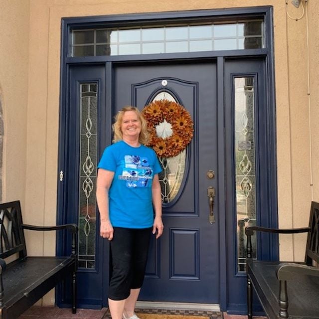 lady in front of blue door