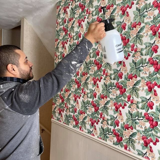 man removing wallpaper