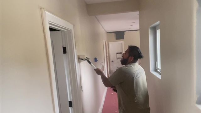 painter painting a hallway