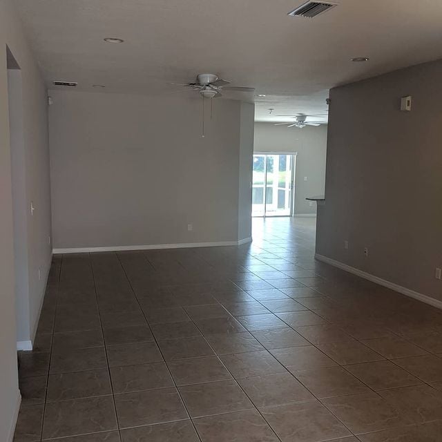 tan rom with white moldings and tile flooring