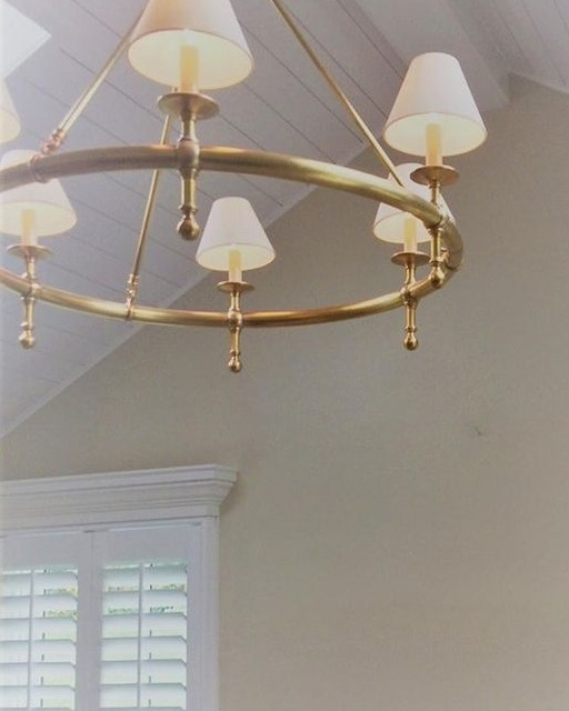 tan wall with white accents and a chandelier