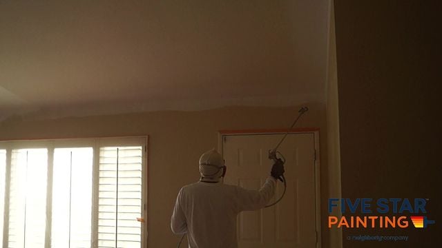 technician painting a room