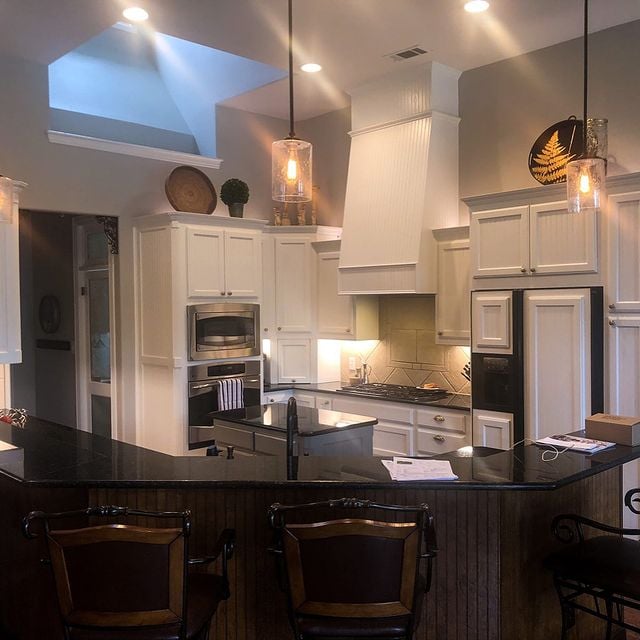 white cabinets with black counters