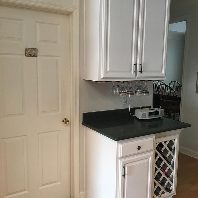 white cabinets with dark granite counter