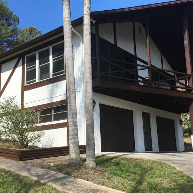 white exterior home with brown trim 