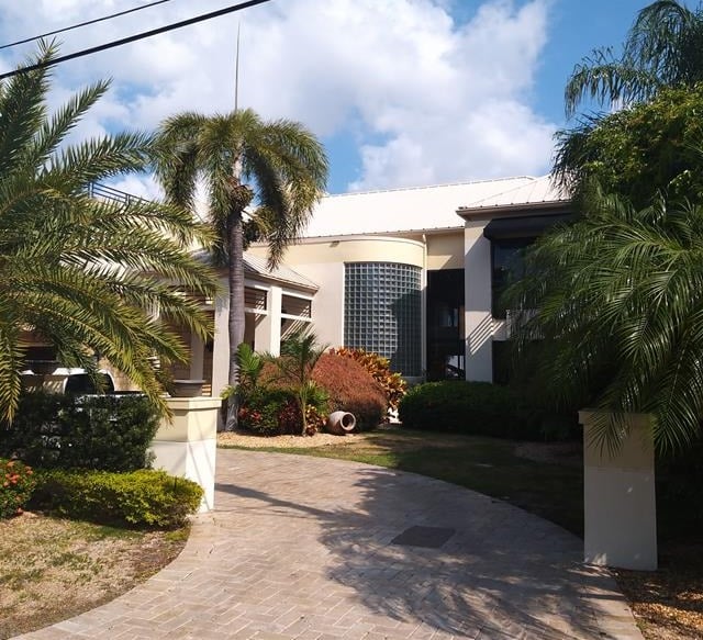 white home with trees in front 