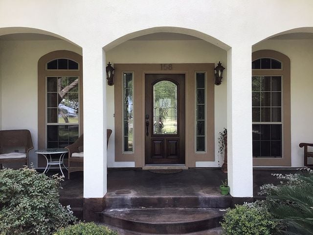 white house with three arches entryway