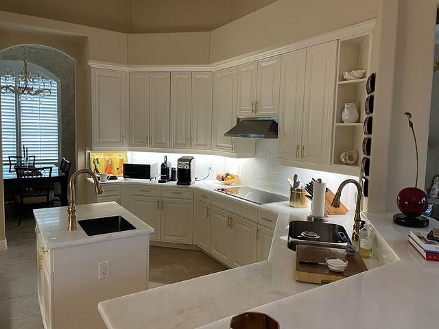 white kitchen cabinets and marble countertops