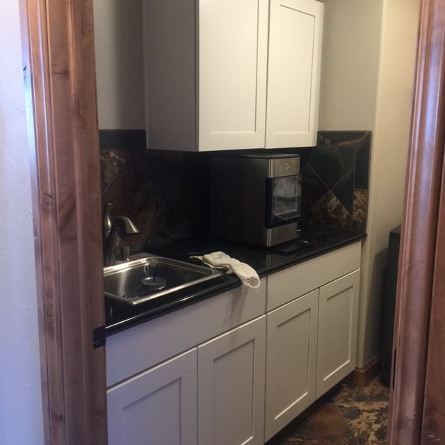 white kitchen with black counter top