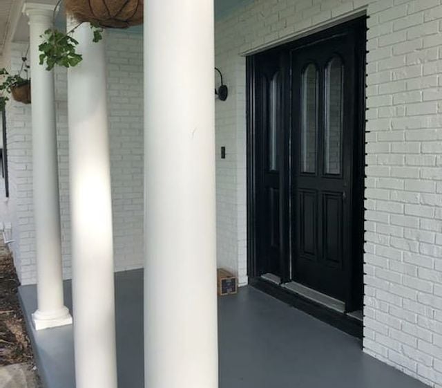 white pillars with black door