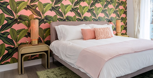 Patterned wallpaper displayed on a wall behind a bed.