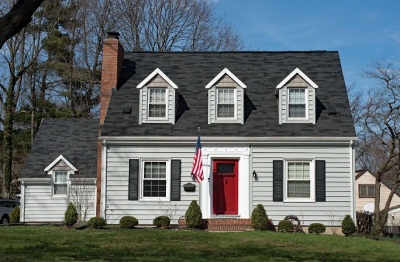 Freshly painted house with vinyl siding and red door.