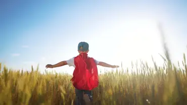 Picture of a small boy dressed in a Superman costume.