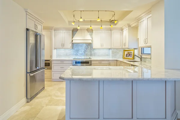 A renovated kitchen with professionally painted white cabinets.