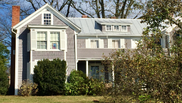 Photo of a two-story house with a front yard.