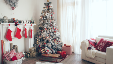 Photo of a white and brown living room decorated for Christmas.