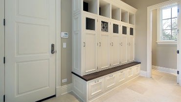 White cabinets against beige wall.