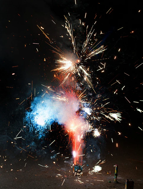 Photo of a firework exploding in red, white, and blue sparks.