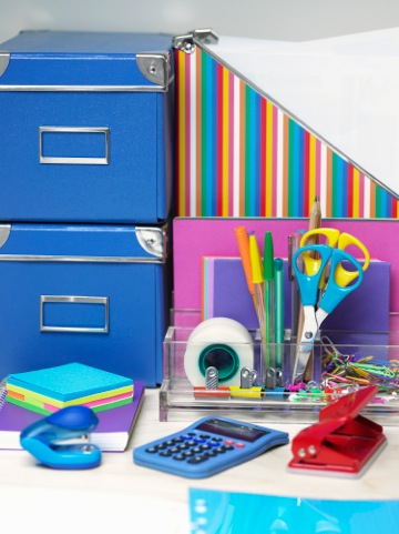Brightly colored office supplies including folders, scissors, sticky notes, small stapler, pens, tap, three whole punch and more Brightly colored office supplies including folders, scissors, sticky notes, small stapler, pens, tap, three whole punch and more.