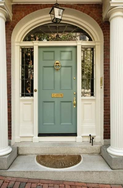 Attractive Front Pork with Olive Green Door, Columns, and Brick Accents Attractive Front Pork with Olive Green Door, Columns, and Brick Accents.