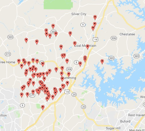 Map with multiple red markers on it.