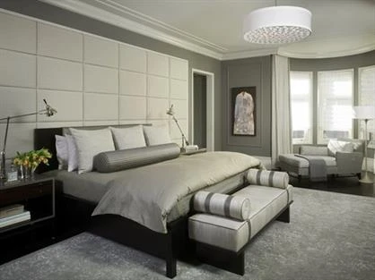 Bedroom with paneled accent wall.