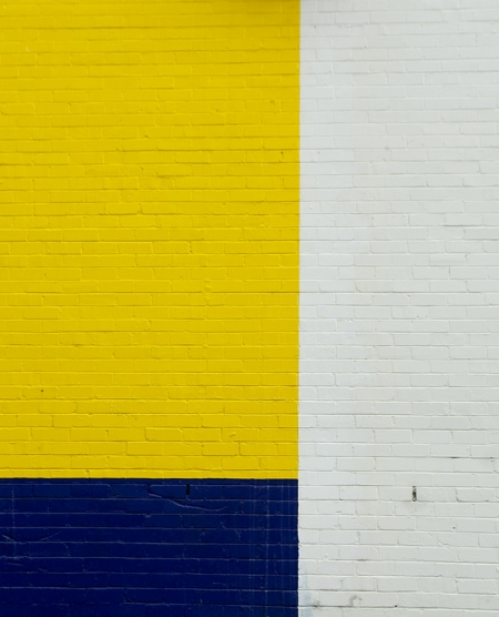Rec Room Paint Yellow, blue, and white brick wall.