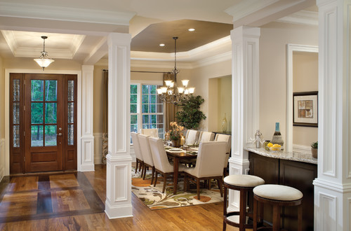 Large living room with white pillars.