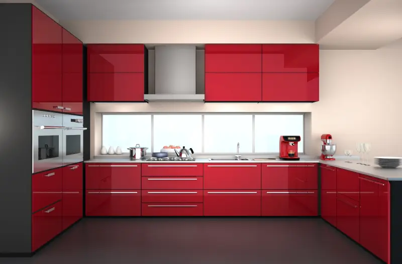 Sleek modern kitchen with bright red cabinets paired with red and steel appliance.