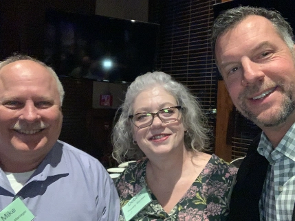 Scott and two people in dinner room .