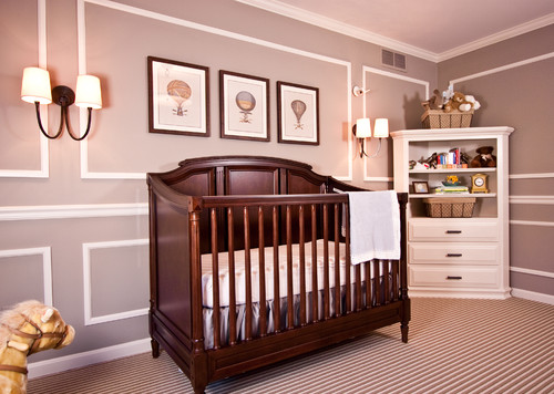 Wooden crib in a mauve-painted bedroom.