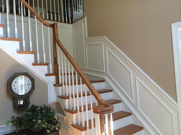 White wainscotting next to stairs.