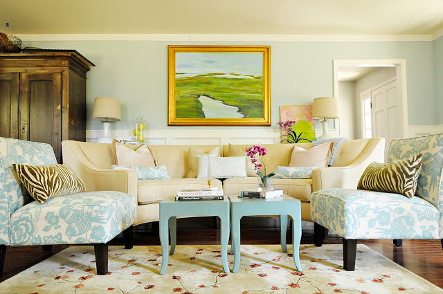 Living room with blue-patterned fabric chairs and cream colored couch.