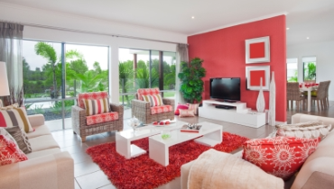 Photo of a large living room with coral accents.