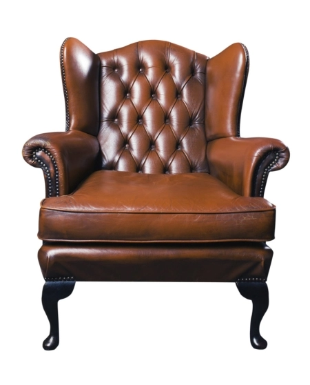 Man Cave Design: Chairs Brown leather wingback chair with tufted backrest and nailhead trim on white background.